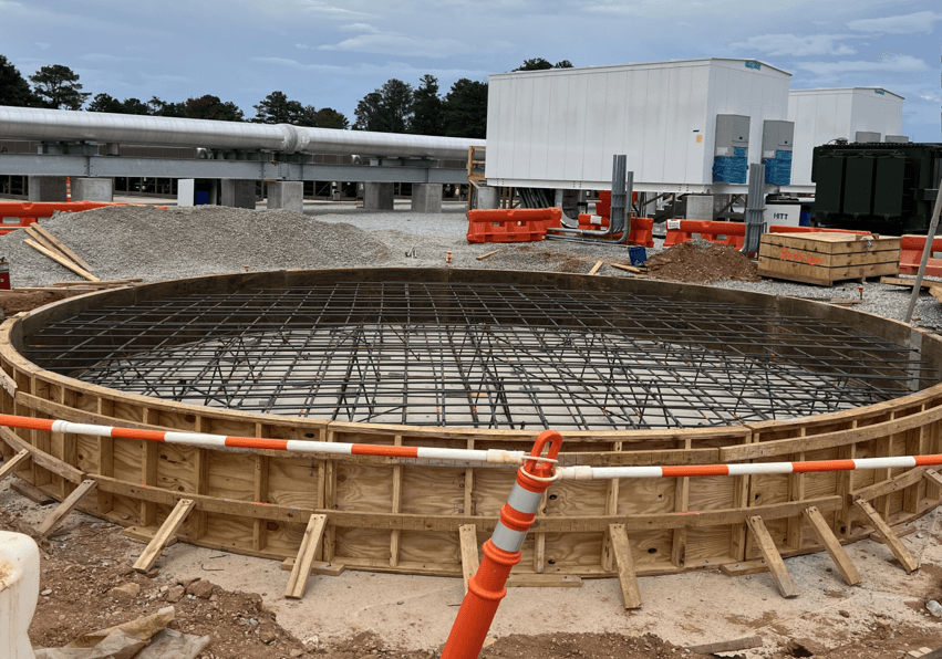 Construction inspector reviewing structural work with tablet in hand
